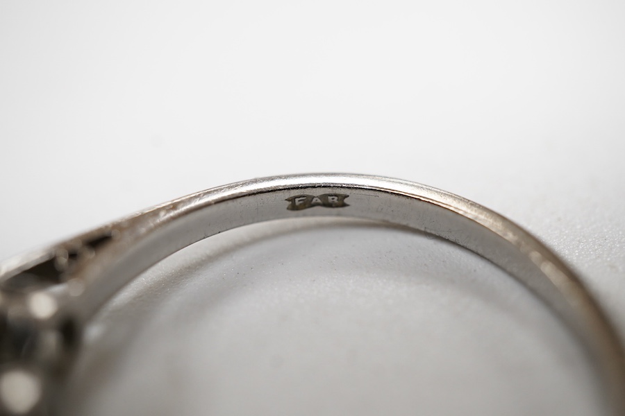 A three-stone diamond ring, set with three brilliant-cut diamonds totalling approximately 0.50 carats, mounted in platinum, size R1/2, British hallmarks, gross weight approximately 4 grams